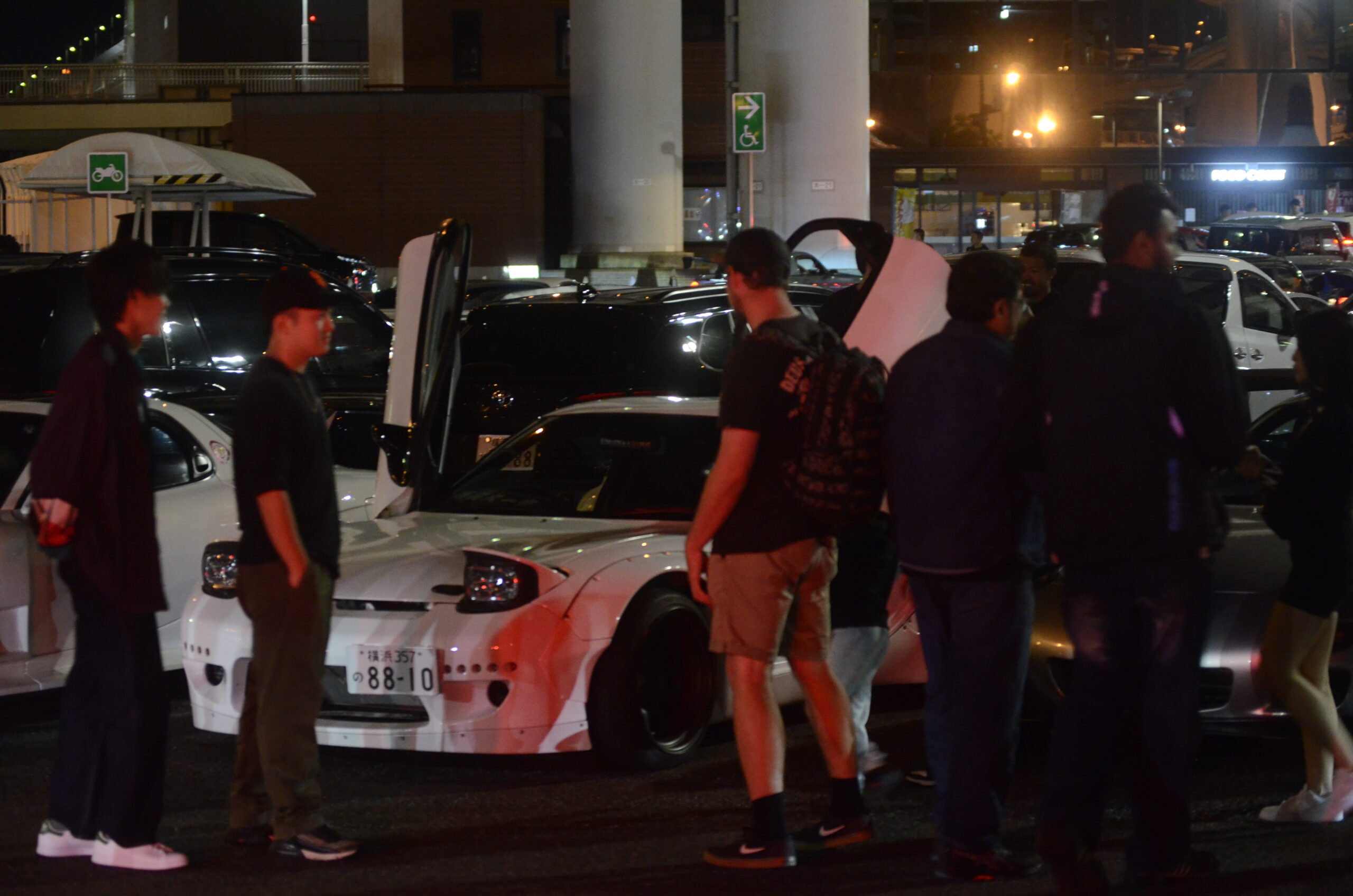 A crowd gathering around our cars at Daikoku